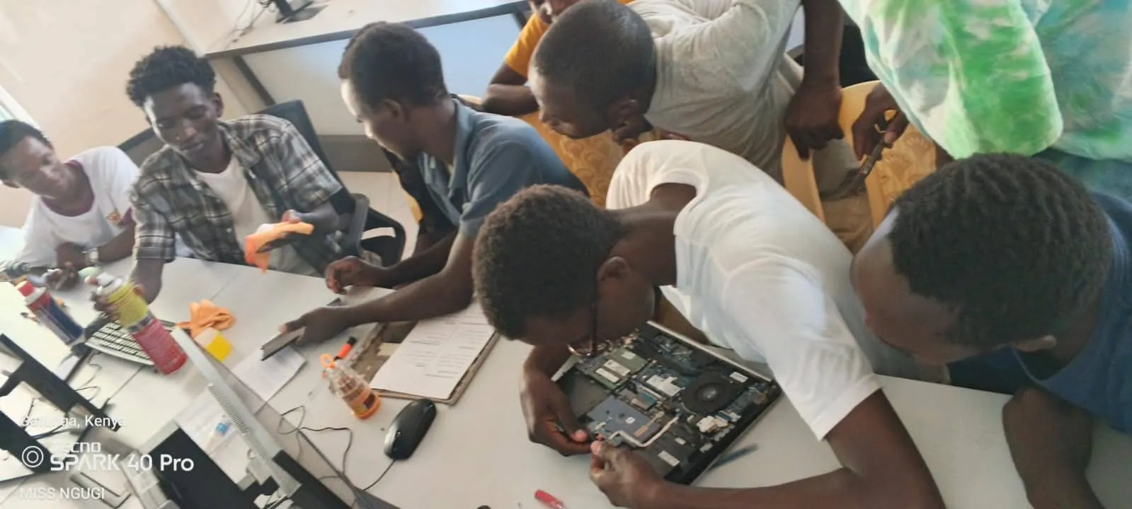 Students repairing laptops in a WaylerTech workshop